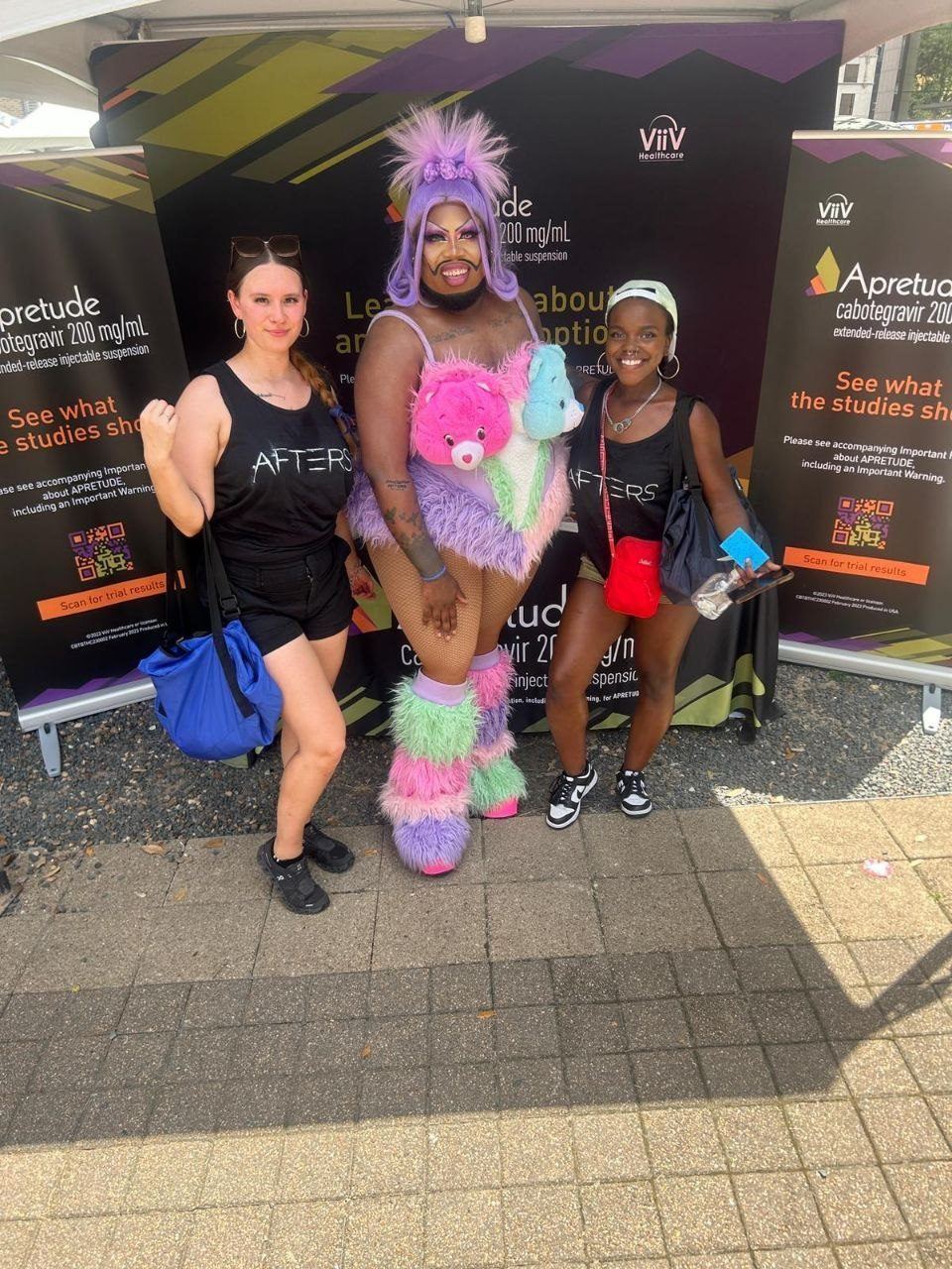 Events — ViiV Healthcare Apretude outdoor activation with costumed performer and two brand ambassadors before branded banners