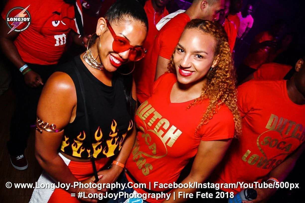 Events — Packed dance floor of attendees in Dutch Soca Lovers shirts at the Fire Fete nightclub party