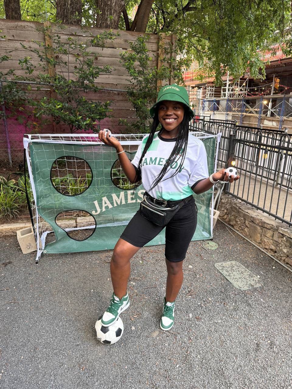 Events — Jameson soccer activation with brand ambassador in branded jersey and bucket hat posing at the target goal