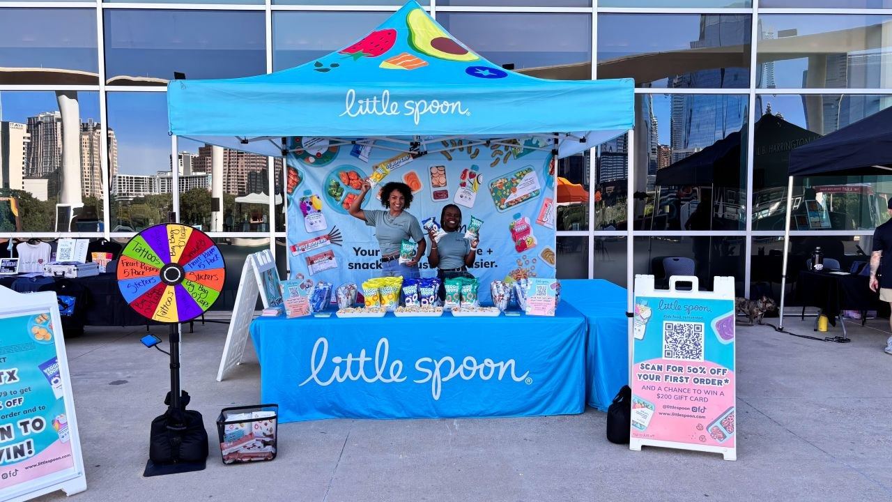 Events — Little Spoon outdoor branded tent activation with two ambassadors, sampling table, and prize wheel