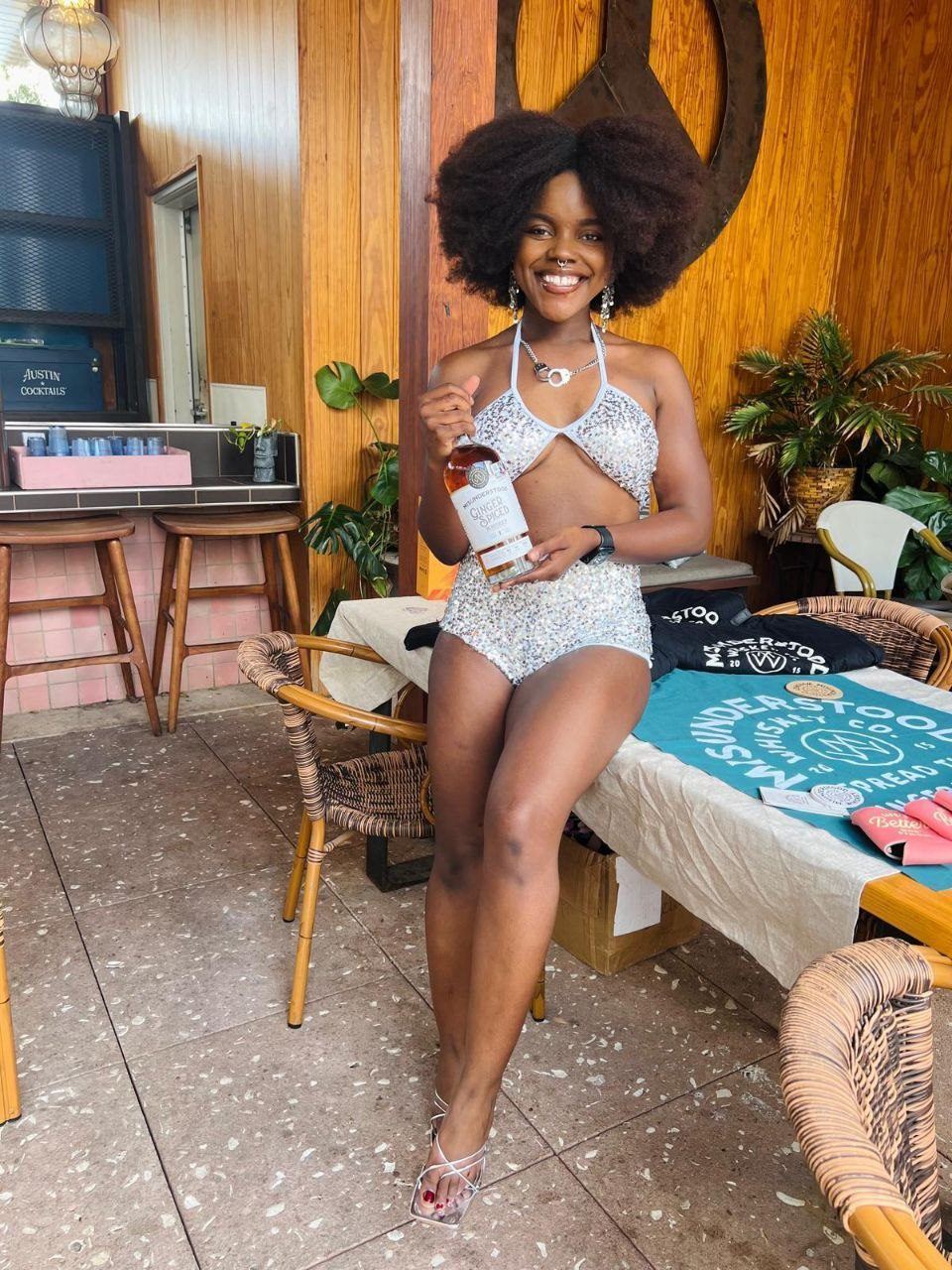 Influencer Work — creator in sequined outfit posing with a bottle at a lifestyle activation
