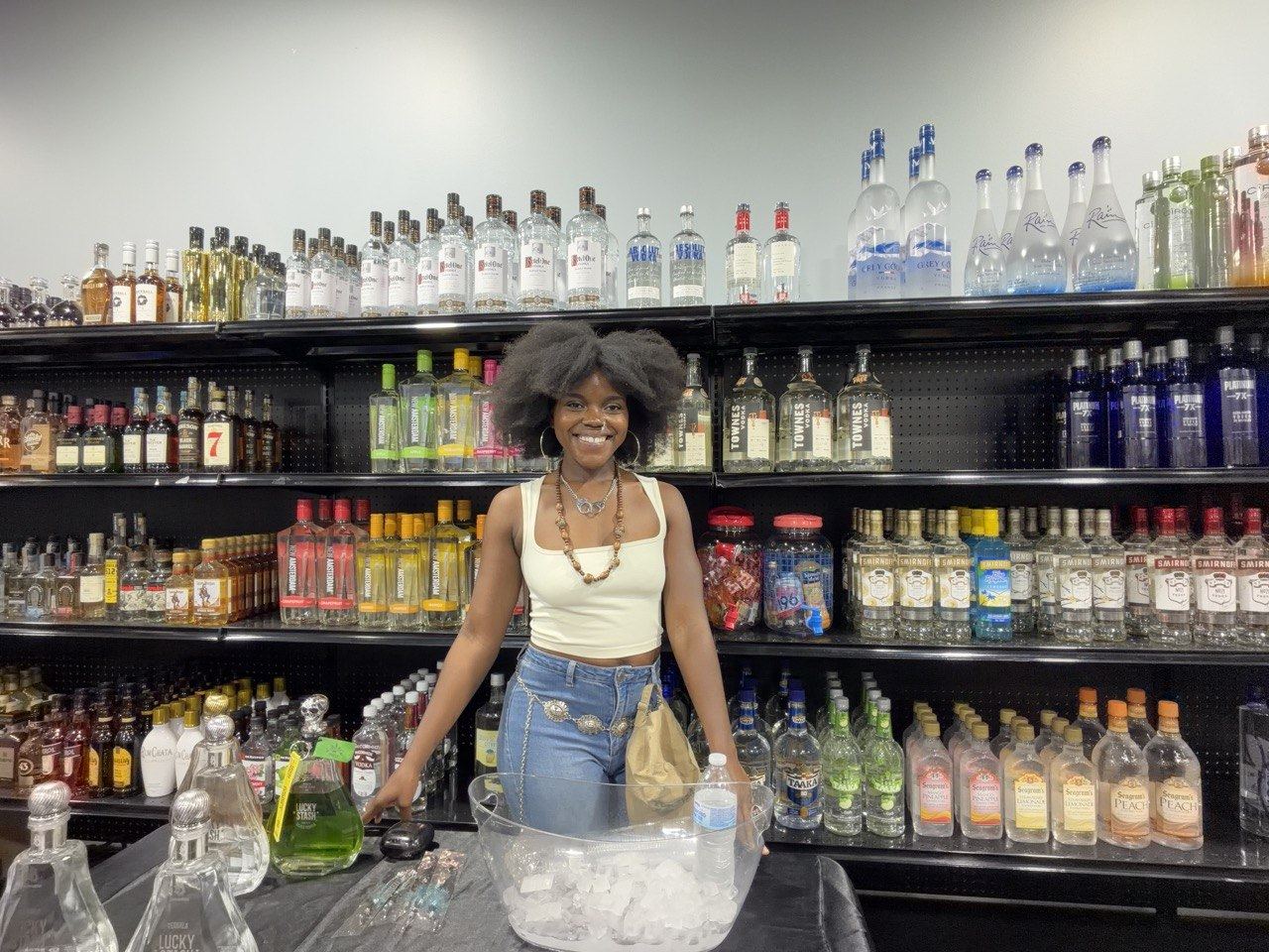 On-Site Activations — Lucky Stash ambassador at a liquor store sampling counter with the green bottles chilling on ice